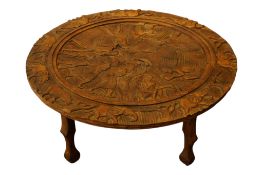 An African carved wood circular table, 100cm in diameter