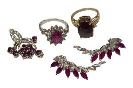 A recent 9ct gold and single stone cabochon star ruby ring, with diamond chip set shoulders, the