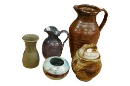 Five pieces of studio pottery to include a David Abbey jug and a jar and cover, indistinct