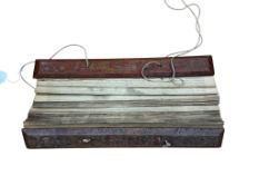 A 19th century Burmese Buddhist Sutra on palm leaves, lacquered covers.