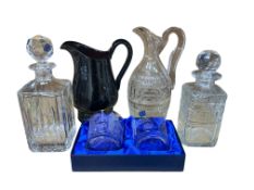 A pair of Royal Scot crystal tumblers (boxed), two spirit decanters, a claret jug and an amethyst