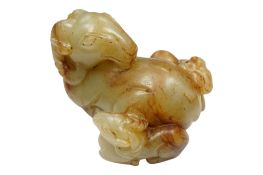A Chinese celadon and russet jade group of a ram and two kids, length 5cm.