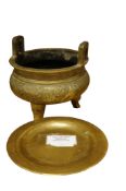 A Chinese engraved bronze tripod censer, height 12cm together with an associated bronze stand (2)