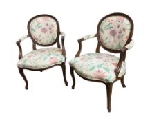 A pair of reproduction mahogany elbow chairs, width 62cm, depth 50cm, height 90cm
