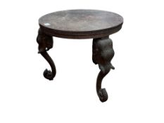 An Indian carved hardwood elephant head table, diameter 63cm, height 60cm