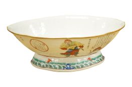A late 19th century Chinese quatrefoil dish with calligraphy, enamelled with figures, 26cm wide