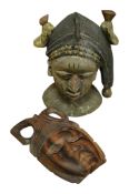A West African polychrome head and an ebony mask, largest 36cm high