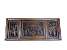 A Chinese wooden plaque carved with figures in three panels, 29 x 69cm