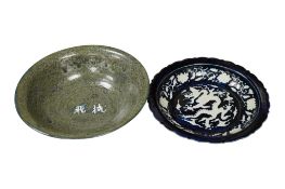 A Chinese cobalt blue and white slip decorated 'dragon' dish, diameter 22cm and a Shiwan type 'oil