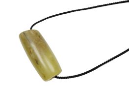 A Chinese bowenite jade cylindrical bead, length 5cm.