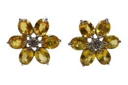 A recent pair of 9ct white gold and yellow sapphire cluster earrings, with central simulated