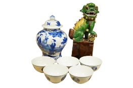 A Chinese blue and white baluster jar and cover, five blue and white bowls and a glazed lion dog