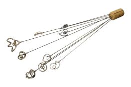 A collection of eight early 20th century silver hat pins by Charles Horner, all with scrolling