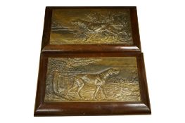 A pair of decorative French bronzed metal plaques of gun dogs, 25 x 43cm