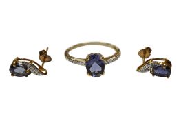 A recent 9ct gold and single stone oval cut iolite ring, with diamond chip set shoulders, size O and