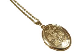 A recent engraved 9ct gold oval locket, overall 40mm, on a 375 chain, gross weight 7.7 grams.