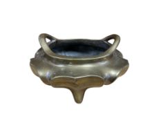 A Chinese heavy bronze tripod censer with twin handles, 17cm high