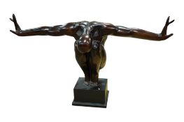 A bronzed statue of a nude figure crouching, on plinth, total height 45cm, arm span 80cm.