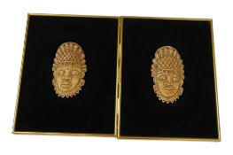 Two Nigerian bone Queen Mother masks, length 16cm, framed, 34 x 26cm.