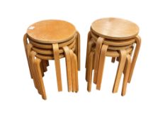 A set of eight Alvar Aalto style bentwood stools, diameter 35cm, height 45cm