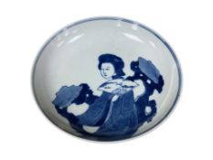 A Chinese blue and white saucer dish, hand painted with a court lady holding a fan, 20cm in