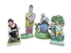 Four early 19th century Staffordshire figures, including Saint Peter, a bocage group, and a mother