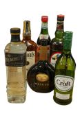 A collection of six bottles of alcohol, comprising Nemiroff De Luxe vodka, Teacher’s Highland
