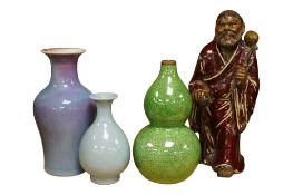 A Chinese pottery figure, height 20cm, a small crackle glazed double gourd vase and two monochrome
