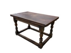 A reproduction 17th century style oak draw leaf refectory table, 226cm extended, width 79cm,