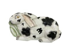 A 19th century Staffordshire spongeware pottery recumbent rabbit, width 24cm