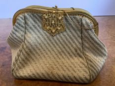 A late 1940’s-50’s silk brocade horizontal striped evening bag. The brocade attached to a shaped