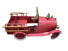 A modern Tri-ang-type child’s “Duke” pedal fire engine, painted pressed steel in red/pink livery,
