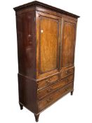 A Regency mahogany linen press, with twin cupboard doors over a base fitted with two short over