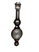 An early 19th century mahogany wheel barometer, with swan neck pediment over silvered dials and