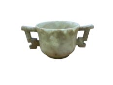 A Chinese bowenite jade two handled cup, 9.5cm wide