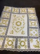 A early 20th century linen bedcover, decorated in the Arts and Crafts style, with heavy silk acorn