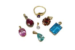 A collection of modern synthetic and paste pendants including two 9ct gold mounted, two 14k mounted,