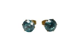 A pair of unmarked yellow metal and blue zircon set ear studs, stone diameter approx. 7mm.