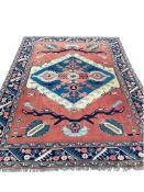 A Turkish red ground geometric carpet, 295 x 219cm
