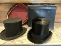 An early 20th century gentleman's collapsible black silk top hat with original red cardboard box.