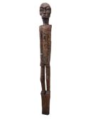 A carved scarecrow, created from a World War II railway sleeper, Philippines. Used by farmers on one