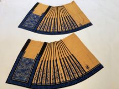 A matching pair of Chinese silk wedding skirts, blue embroidery on ochre silk, 77cm long x 90cm