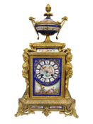 A French gilt bronze and Sevres style porcelain mantel clock, striking on a bell, with pendulum