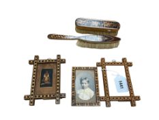 Three Tunbridge ware photograph frames and two brushes, largest 24cm in length