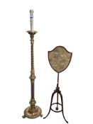 A 19th century giltwood standard lamp, along with a mahogany pole firescreen, the shield shaped