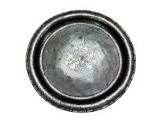 An Arts and Crafts Hugh Wallis hammered copper inlaid dish, stamped, 25cm in diameter