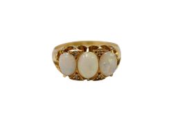 An early 20th century 18ct gold and three stone opal ring, with diamond chip spacers, size M,