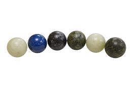 Six hardstone carved spheres, 5cm in diameter