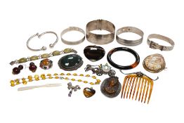 A collection of jewels including a tiger's eye quartz heart pendant, two silver cuff bracelets