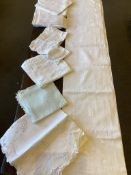 A collection of table linen cloths, including damask, various cut work cloths, an embroidered and